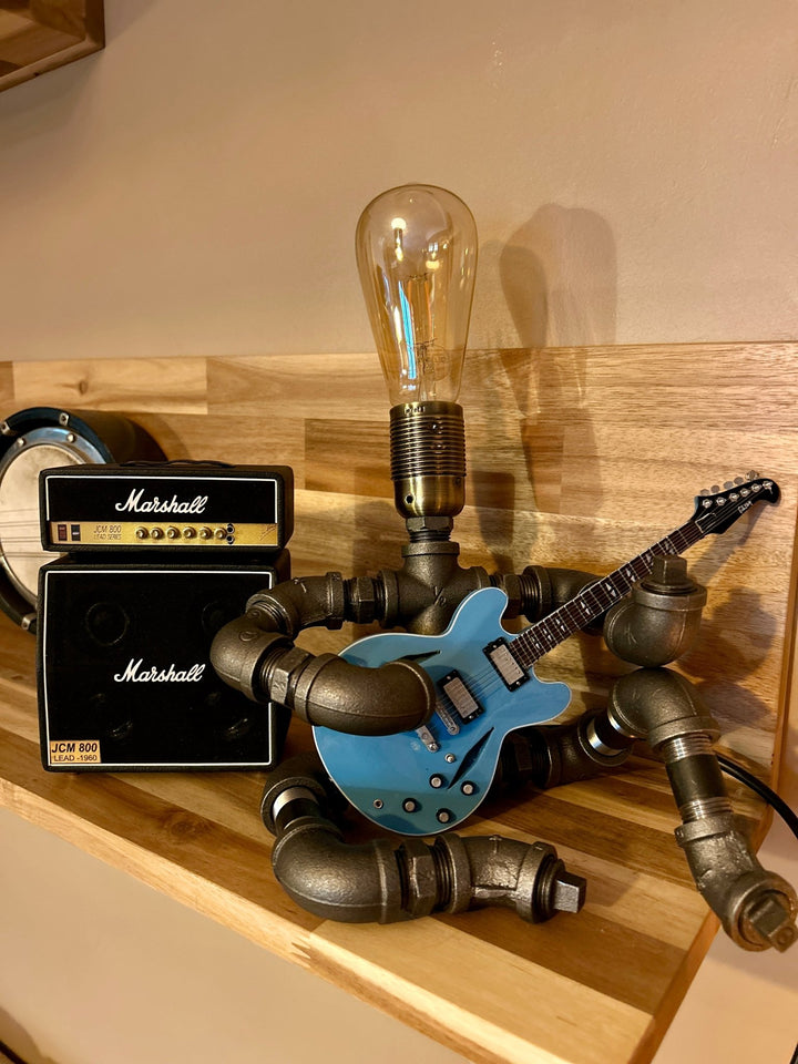 Guitar lamp with mini Marshall amplifier on a wooden surface