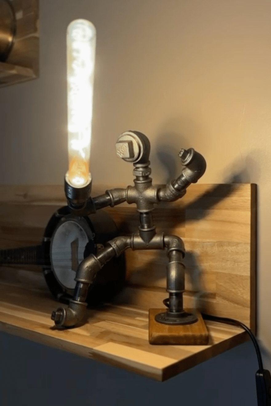 Industrial-style pipework table lamp in the style of a Jedi knight with lightsaber