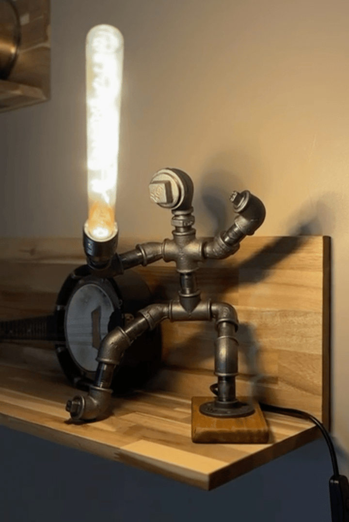 Industrial-style pipework table lamp in the style of a Jedi knight with lightsaber