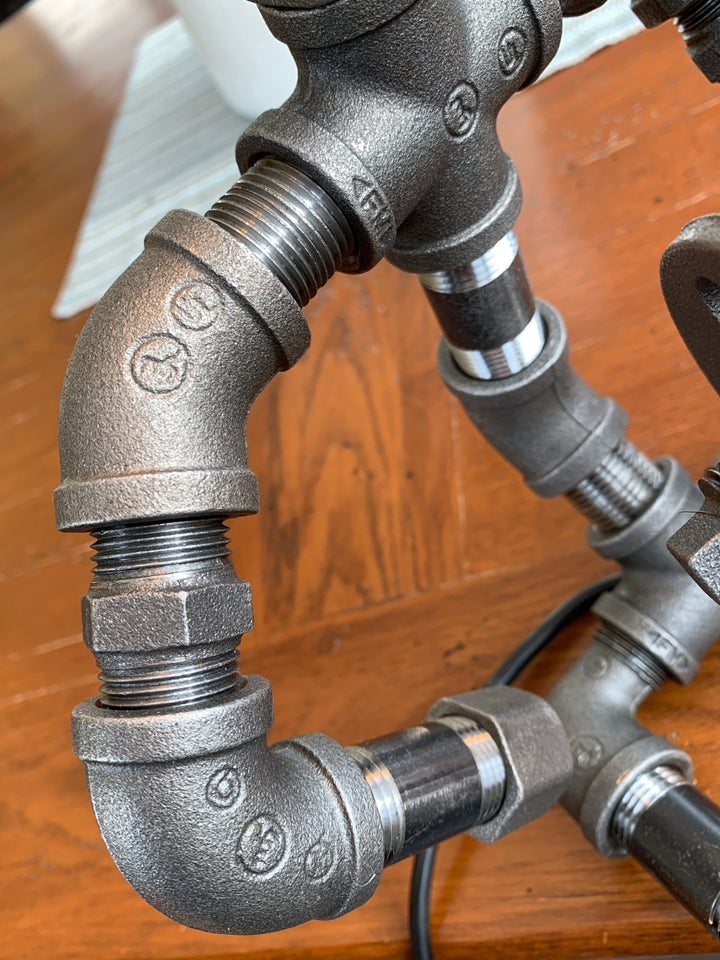 photo showing the pipe parts that the guitar hero lamps are made from