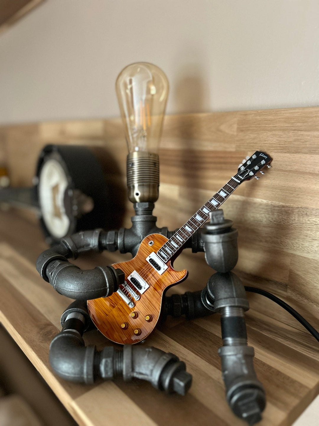 Pipework Guitar lamp holding a Slash inspired miniature guitar