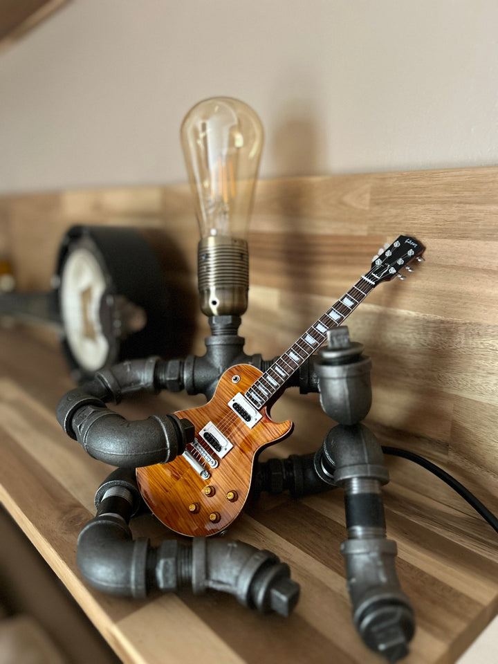 Pipework Guitar lamp holding a Slash inspired miniature guitar