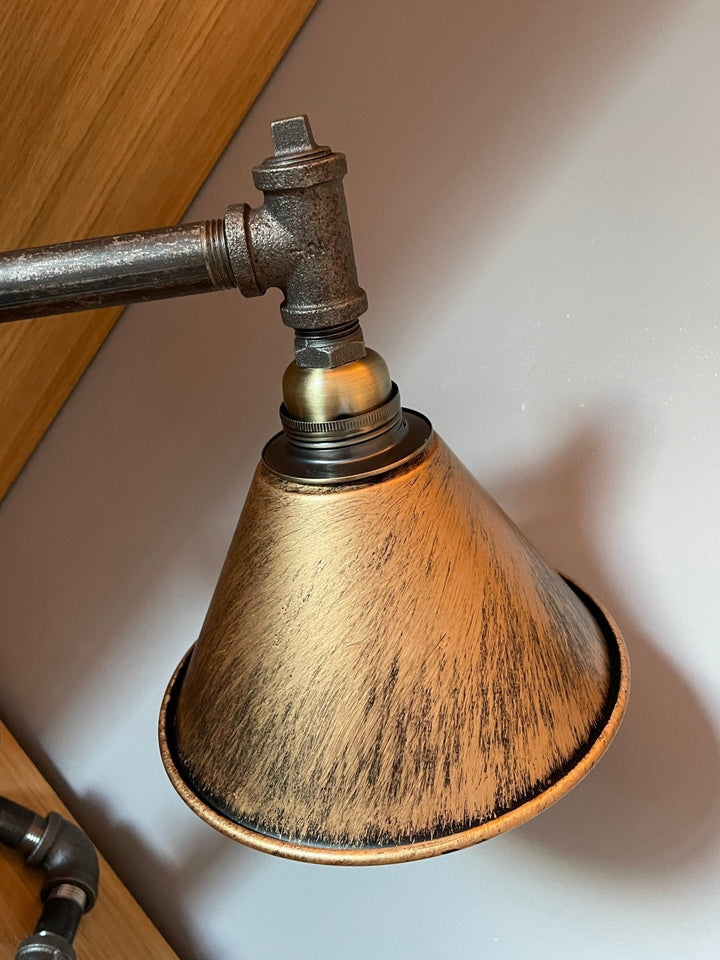 Copper coloured lampshade closeup on pipework table lamp