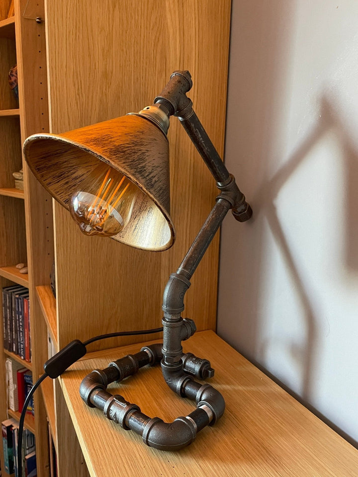 Industrial pipework lamp on a wooden bookcase