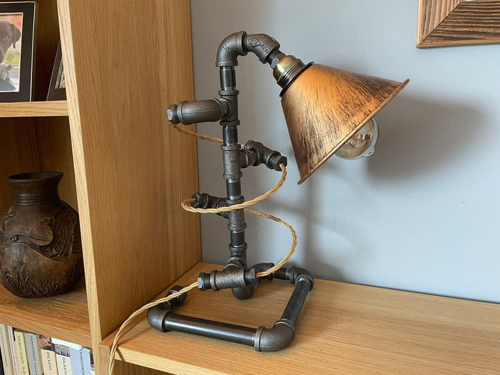 Steampunk-style lamp with gold cable spiralling around the lamp